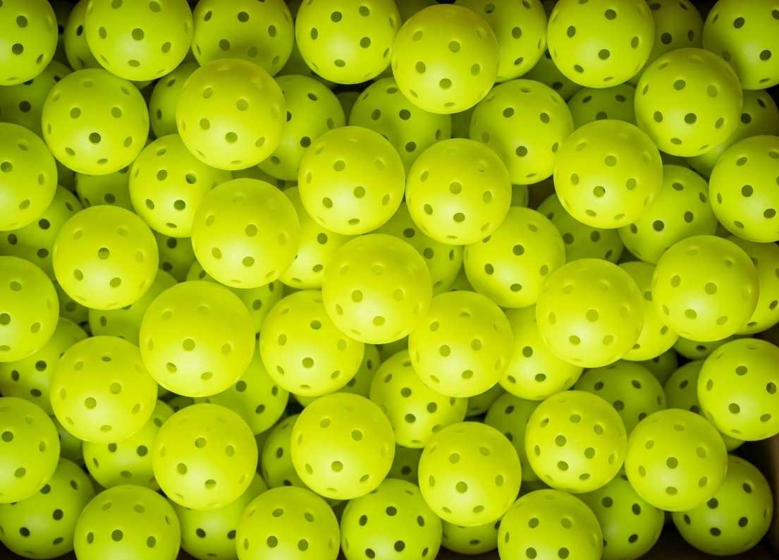 Three outdoor pickleballs